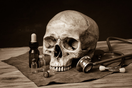 still life with human skull and stethoscopeの写真素材