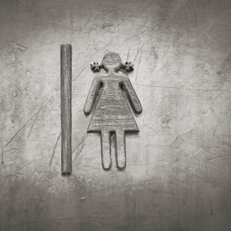 Restroom sign made of teak wood on concrete wallの写真素材