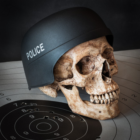 Human skull wear police helmet with bull eye target as the backgroundの写真素材
