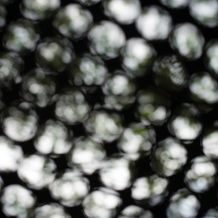 Texture of bokeh, view of boken through the circle on metal sheetの写真素材