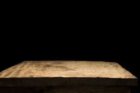 Background with wooden deck tabletop and black wallの写真素材