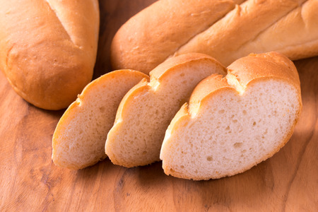 Slide breads on wooden tableの写真素材