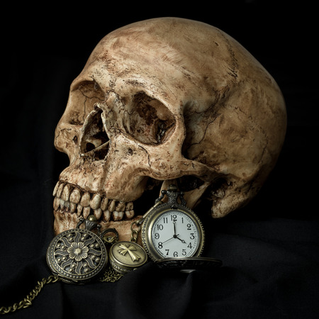 Still life, human skull with antique pocket watchesの写真素材