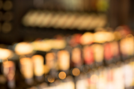 Line of wine bottles display in store, soft focusの写真素材