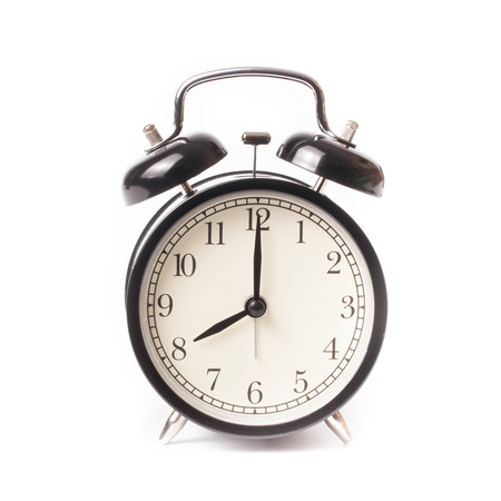 Retro alarm clock on isolated white backgroundの写真素材