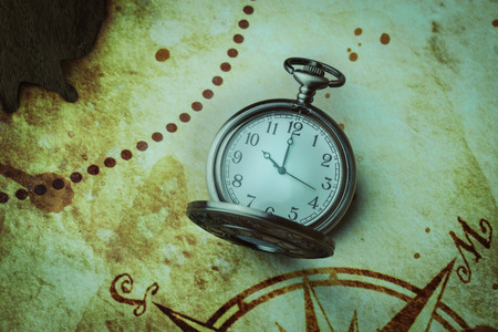 Vintage antique pocket watch on old map backgroundの写真素材