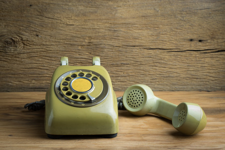 Still life with old green telephone on wooden tableの写真素材