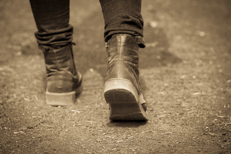 Concept move forward, step with boots on ground floorの写真素材