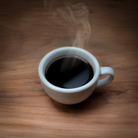 Coffee cup on old wooden background, top viewの写真素材