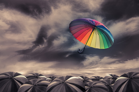 rainbow umbrella fly out the mass of black umbrellas rainbow umbrella fly out the mass of black umbrellas