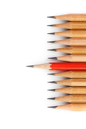 concept different from the crowd, red pencil in the row of brown pencilsの写真素材