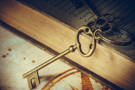 old keys on a old book, antique texture backgroundの写真素材