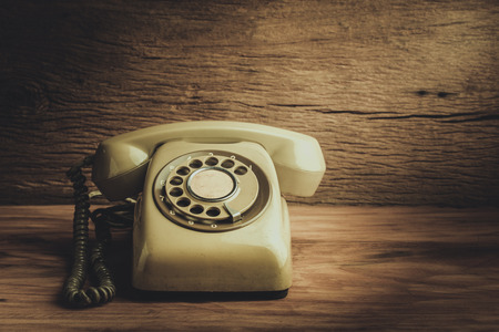 Still life with old green telephone on wooden tableの写真素材
