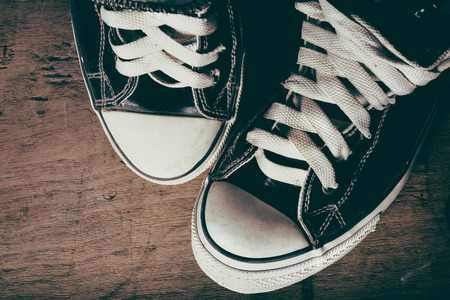 Old sneakers on wood surface, vintage styleの写真素材