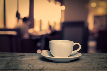 cup of coffee on table in cafe, vintage styleの写真素材
