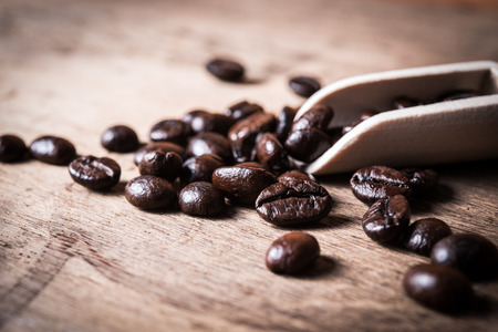 Coffee beans in wooden scoopの写真素材