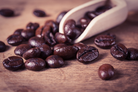 Coffee beans in wooden scoopの写真素材