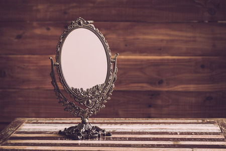 Classic mirror on wooden table, vintage styleの写真素材
