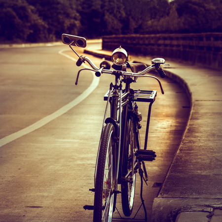 Old bicycle on the bridge, vintage effect style.の写真素材