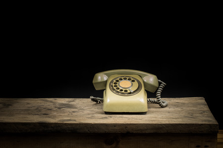 Still life, old telephone on wooden tableの写真素材