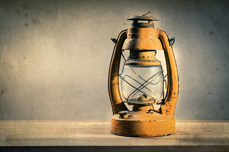 Still life old kerosene lantern on wooden table, effect by vintage styleの写真素材