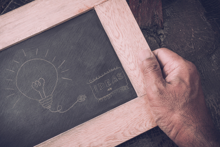 idea image written on black board in man's hand, vintage effectの写真素材
