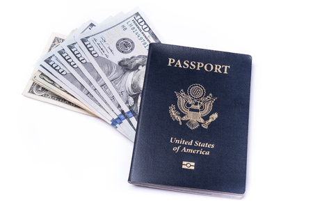 US passport and dollar bills on isolated white backgroundの写真素材