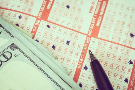 Lotto ticker with pen and one hundred dollar billsの写真素材