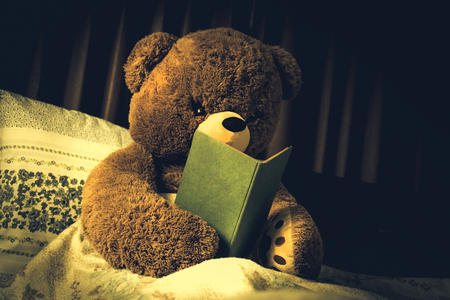 Teddy bear read the book in bed, effect by vintage styleの写真素材