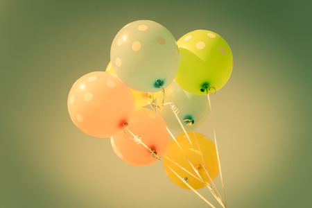 Colorful balloons on blue sky background in vintage color styleの写真素材