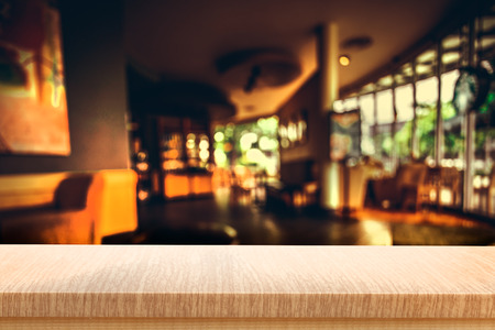 Empty top of wooden table or counter on cafeteria, bar, coffeeshop background. For product displayの写真素材