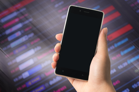 A man holding modern smart phone with blank screen in hand. Closeup shot. Concept for travel communicationの写真素材