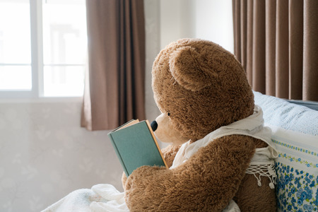 Teddy bear read the book in bed, effect by vintage styleの写真素材