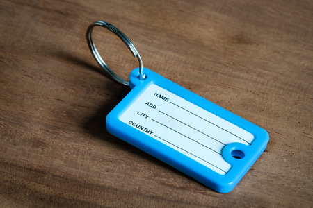 Blank name tag on wooden backgroundの写真素材