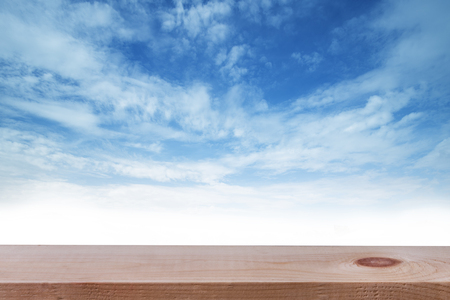 Empty top of wooden table or counter and blured image of blue sky. For product displayの写真素材