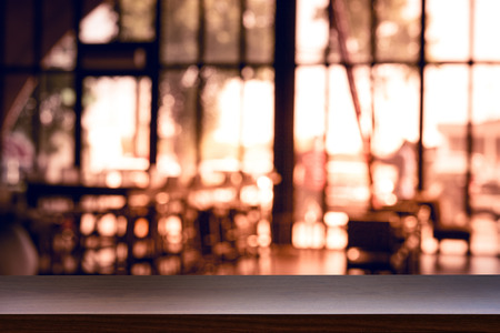 Empty top of wooden table or counter on cafeteria, bar, coffeeshop background. For product displayの写真素材
