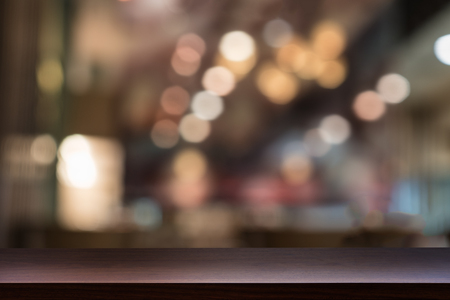 Empty top of wooden table, shelf or counter on cafeteria, bar, pub, coffeeshop background. For product displayの写真素材