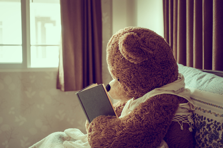 Teddy bear read the book in bed, effect by vintage styleの写真素材