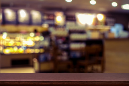 Empty top of wooden table or counter on cafeteria, bar, coffeeshop background. For product displayの写真素材