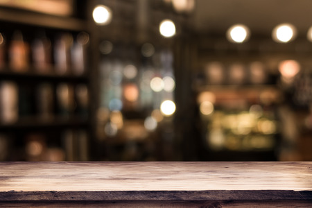 blurred background of bar and dark brown desk space of retro woodの写真素材