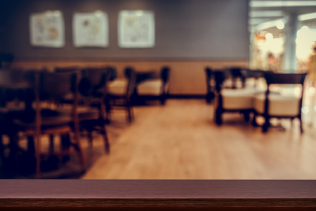 Empty top of wooden table or counter on cafeteria, bar, coffeeshop background. For product displayの写真素材