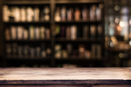 blurred background of bar and dark brown desk space of retro woodの写真素材