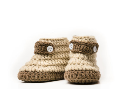 brown shoes of baby on white background crochet baby booties isolated on white, Hand-made baby...