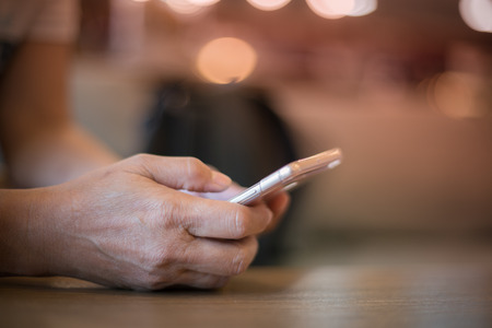 Middle aged woman using mobile phone connect to social network, technology conceptの写真素材