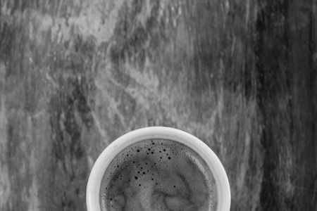 Top view of half hot coffee cup on wooden table hot coffee cup on wooden tableの写真素材