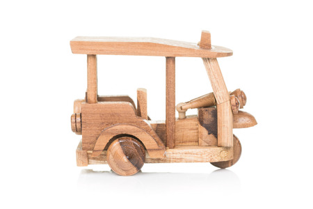 tricycle local thai taxi 'Tuk Tuk'  wooden toy isolated on white backgroundの写真素材
