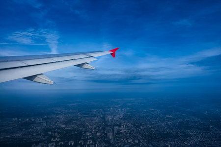 Bright blue sky, view from airplane window see the city below