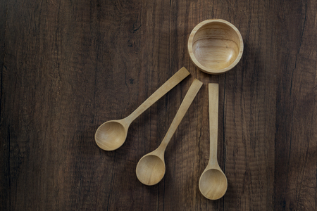 wooden bowl and spoon on wooden tableの写真素材