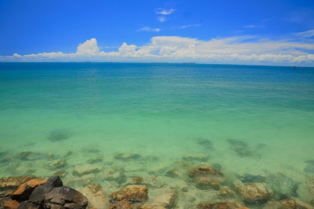 Clear water and white sand beach in daytime の写真素材