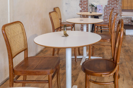 Modern and stylish dining room interior with glamour wooden table, elegant vintage chairs and design...